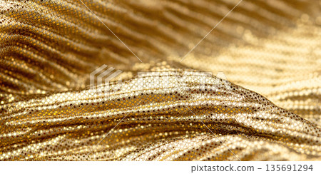A close-up shot of gold sequin fabric 135691294