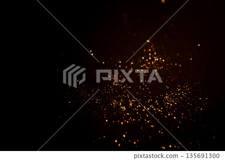 Golden abstract bokeh on black background. 135691300