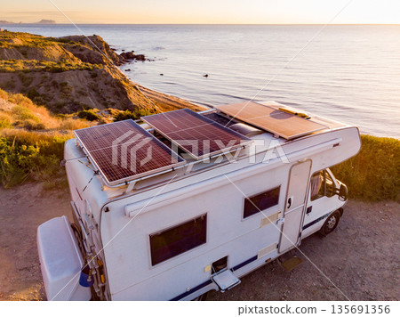 Caravan with solar panels on roof camp on coast, Spain. Aerial view. Caravan with solar panels on roof camp on coast, Spain. Aerial view. 135691356