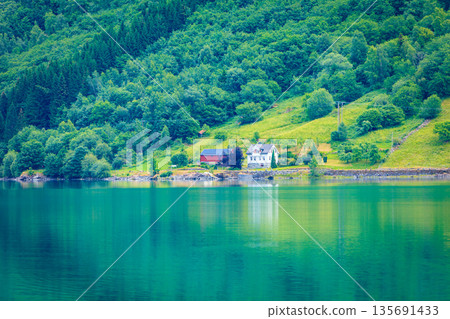 Norwegian country houses in the mountains on lake shore Norwegian country houses in the mountains on lake shore 135691433