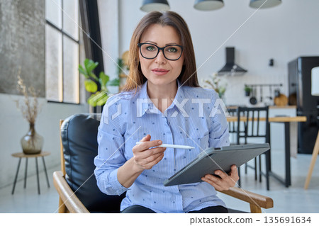 Webcam view woman entrepreneur, teacher working online remotely in home office 135691634
