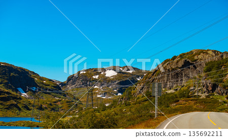 Power line voltage tower in mountains 135692211