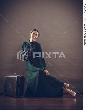 Woman retro style with old suitcase camera 135692847