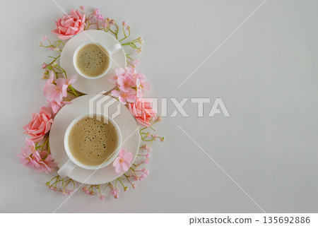 Coffee Cups and Pink Flowers in Shape of Eight. Elegant Flatlay for International Womens Day Coffee Cups and Pink Flowers in Shape of Eight. Elegant Flatlay for International Womens Day 135692886