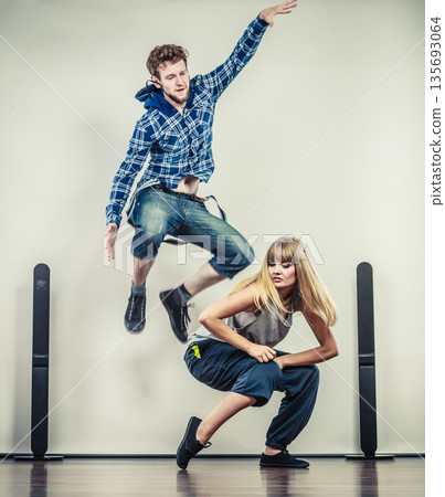 couple of young man and woman dancing hip-hop couple of young man and woman dancing hip-hop 135693064