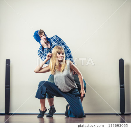 couple of young man and woman dancing hip-hop couple of young man and woman dancing hip-hop 135693065