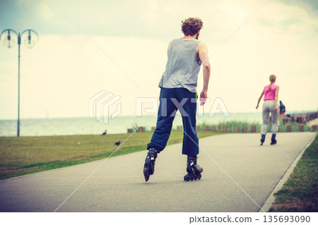 roller skater couple skating outdoor roller skater couple skating outdoor 135693090