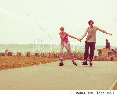 roller skater couple skating outdoor 135693091
