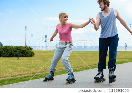roller skater couple skating outdoor 135693093