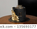 Luxury black birthday cake with gold leaf decoration 135693177