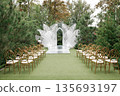 Elegant Outdoor Wedding Ceremony Setup in Garden 135693197