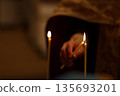 Orthodox Priest Lighting Candle During Child Baptism 135693201