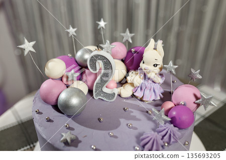 Cute birthday cake with number 2 and bunny decoration Cute birthday cake with number 2 and bunny decoration 135693205