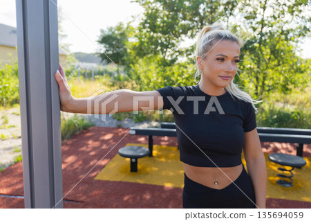 Woman enjoying an outdoor workout session dressed in athletic wear Woman enjoying an outdoor workout session dressed in athletic wear 135694059