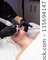 Close-up of cosmetology hardware treatment focused on healthy glowing skin and anti-aging care. 135694147