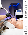 Professional facial skincare treatment using modern cosmetic device in a beauty clinic with advanced technology. 135694148