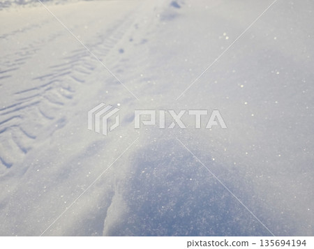 Snow Covers the Ground With Texture and Sparkles in Sunlight During Winter Season in a Remote Area Snow Covers the Ground With Texture and Sparkles in Sunlight During Winter Season in a Remote Area 135694194