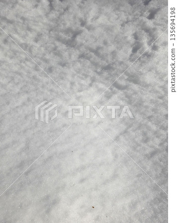 Soft Snow Texture Found on the Ground During Winter at a Quiet Outdoor Location in Daytime 135694198