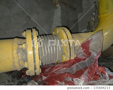 Gas Pipe Expansion Joint Connection in Industrial Setting Observed During Morning Maintenance Work Gas Pipe Expansion Joint Connection in Industrial Setting Observed During Morning Maintenance Work 135694213