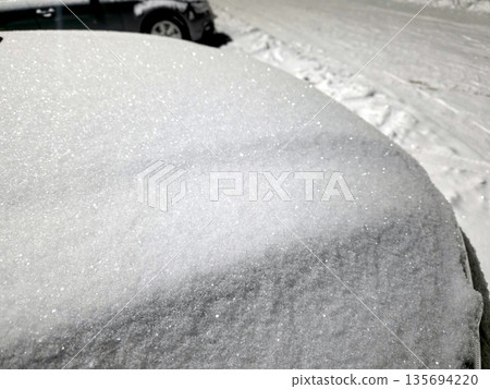 Snow Covers the Surface of a Car Parked on a Street During Winter in a Snow Filled Neighborhood 135694220