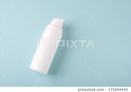 Skincare hydration background with water drops and cosmetic bottle 135694440