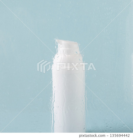 Skincare hydration background with water drops and cosmetic bottle 135694442