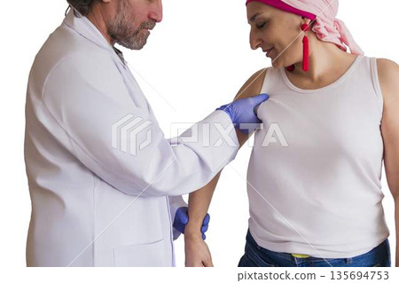 Doctor performing breast cancer screening on woman 135694753
