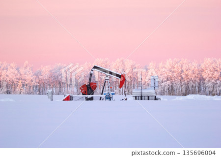 Snow Covered Oil Pumpjack at Winter Sunrise Snow Covered Oil Pumpjack at Winter Sunrise 135696004