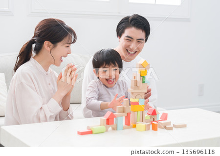 Family playing with building block toys Family playing with building block toys 135696118
