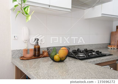 Modern kitchen interior with gas stove and fruit bowl Modern kitchen interior with gas stove and fruit bowl 135696272