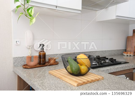 Kitchen counter with fruit bowl and cooking area 135696329