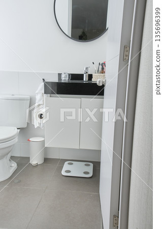 Modern bathroom interior showing vanity sink and scale 135696399
