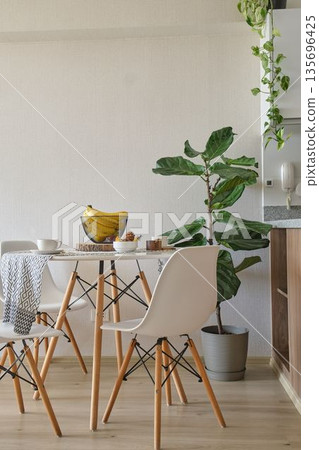 Modern dining room interior featuring minimalist design and plants 135696425