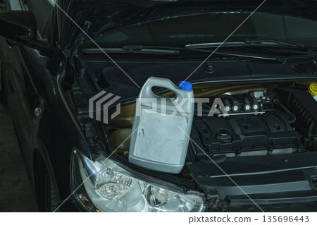 Car engine with oil bottle for maintenance service Car engine with oil bottle for maintenance service 135696443