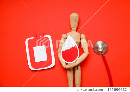 Mannequin with blood drop and bag on red background 135696682