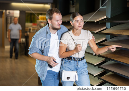 Married couple chooses sample of laminate flooring in store Married couple chooses sample of laminate flooring in store 135696730