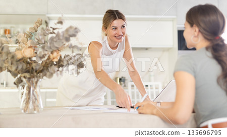 Woman agent communicates with client and makes deal with him 135696795