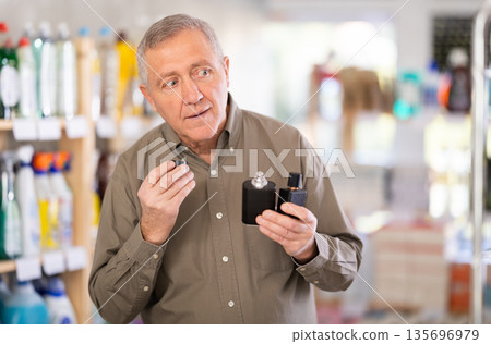 man chooses a perfume in a store 135696979