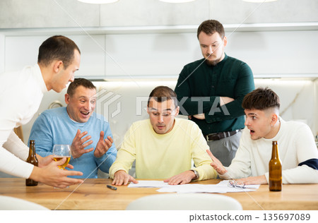 Friends consoling upset worried man reading unexpected medical results 135697089