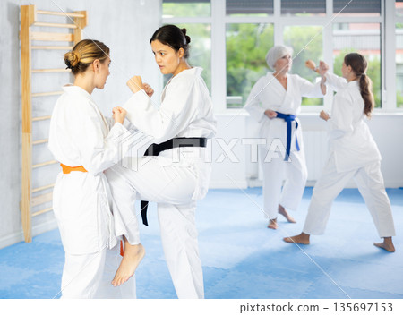 Two young women training self-defense techniques Two young women training self-defense techniques 135697153