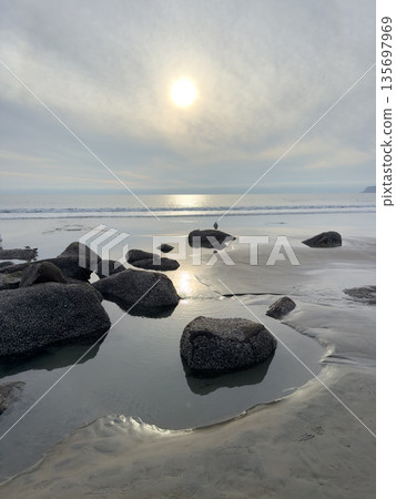 Stunning view at beach with coastal rocks and clear ocean water 135697969