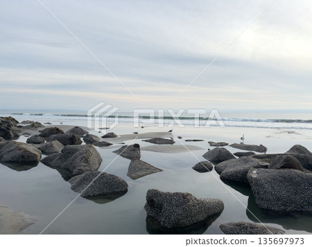 Stunning view at beach with coastal rocks and clear ocean water Stunning view at beach with coastal rocks and clear ocean water 135697973