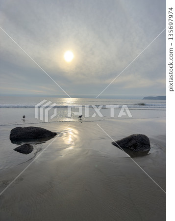 Stunning view at beach with coastal rocks and clear ocean water Stunning view at beach with coastal rocks and clear ocean water 135697974