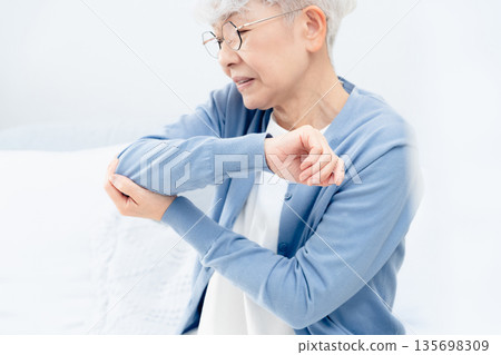 Senior woman with elbow pain Senior woman with elbow pain 135698309