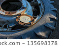 Old tractor wheel with morning rime frost 135698378