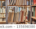 Many book shelves in a library 135698380