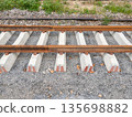 New railway tracks under construction on concrete sleepers. 135698882