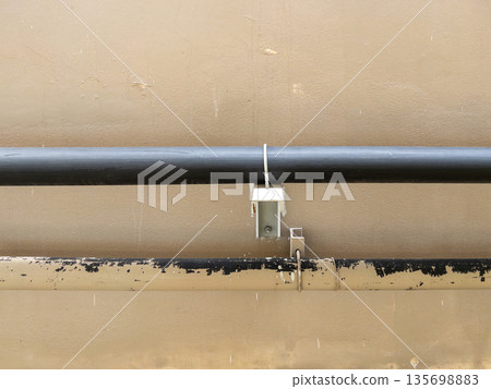 Industrial HVAC pipes with rubber insulation on building walls. Industrial HVAC pipes with rubber insulation on building walls. 135698883