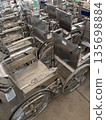 Organized metal wheelchairs in hospital entrance hall. 135698884