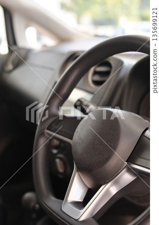 Car Steering Wheel and Dashboard Features 135699121
